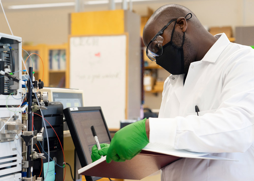 Isaiah Odoyo, a research scientist in the Cech Laboratory, works to identify molecules in a complex extract being studied for its potential to treat infections.