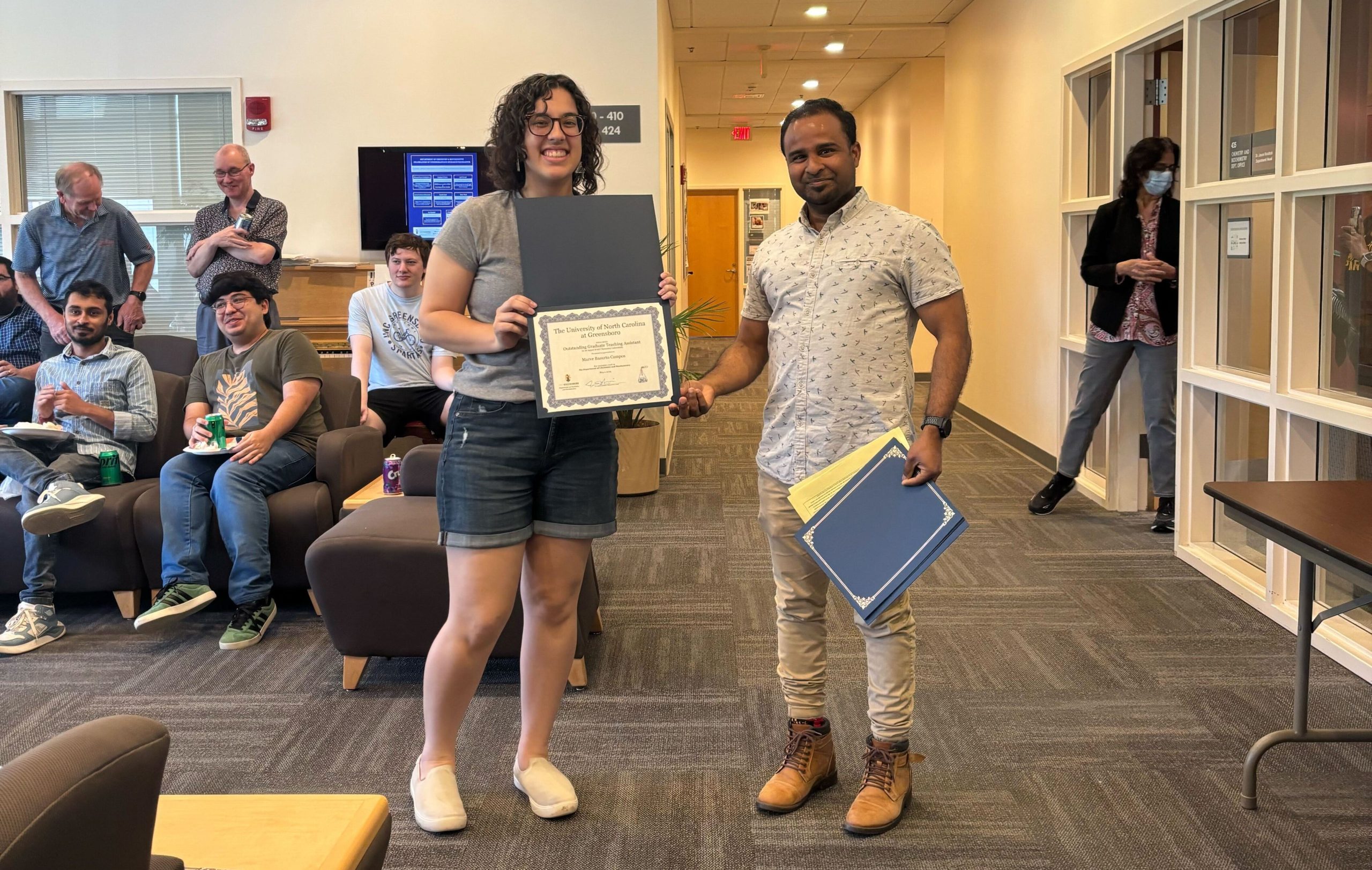 Audrey Gay holds up her award certificate
